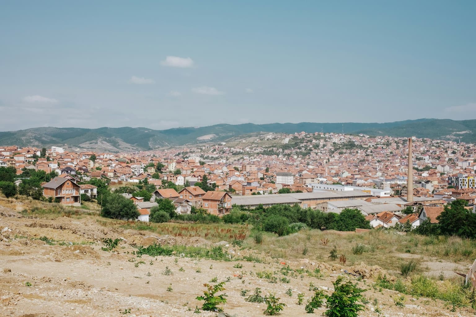 View across the rooftops of Pristina toward the surrounding hills